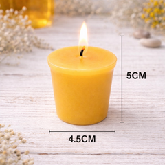 Yellow candle with dimensions on a light wooden surface with blurred background