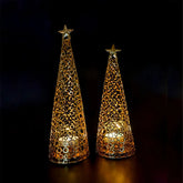 Two decorative cone-shaped lights with star tops on a dark background