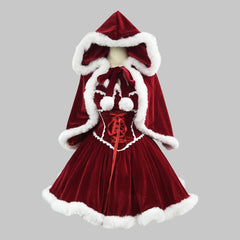 Red velvet dress with white fur trim on a gray background