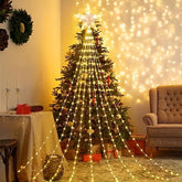 Decorated Christmas tree with string lights in a cozy living room setting.