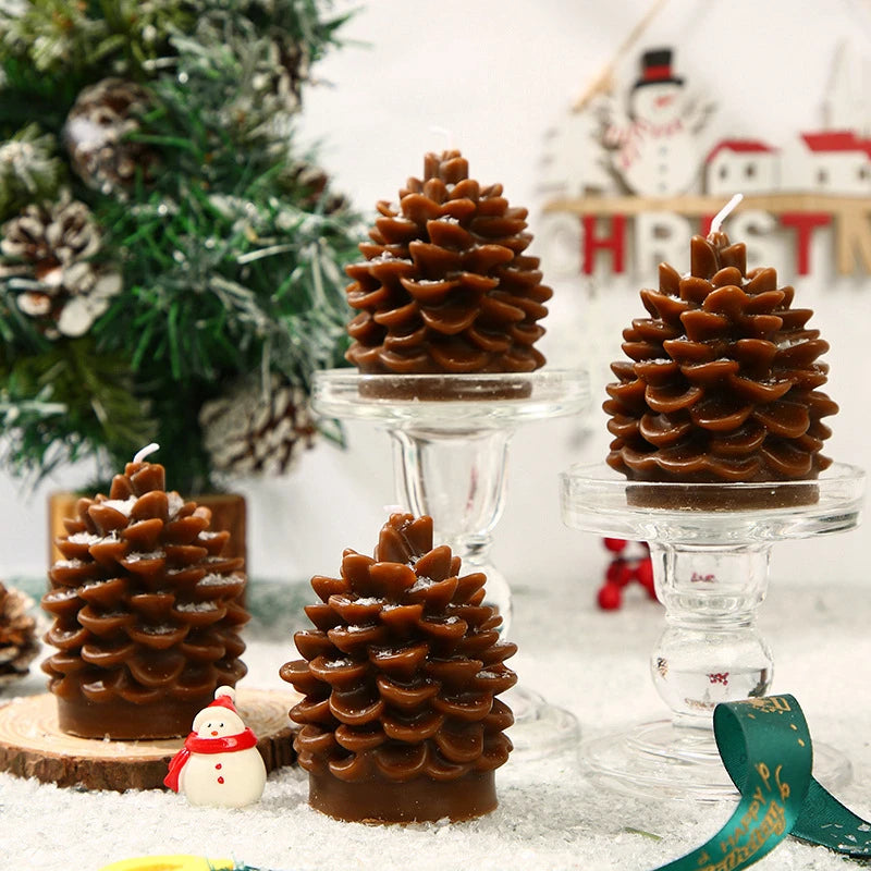 Chocolate pine cone candles on a festive background with Christmas decorations.