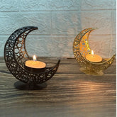Two decorative candle holders shaped like crescent moons on a wooden surface.