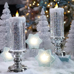 Decorative candles with silver glittery bases in a festive setting with Christmas trees and lights.