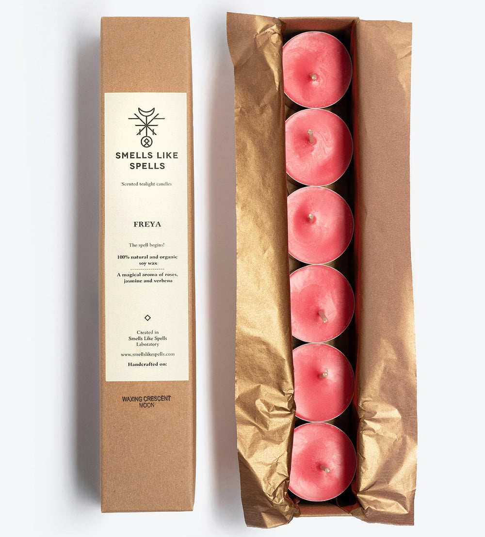 Set of pink candles in a brown box with 'Smells Like Spells' packaging on a white background