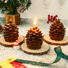 Pine cone-shaped candles on wooden bases with a festive background