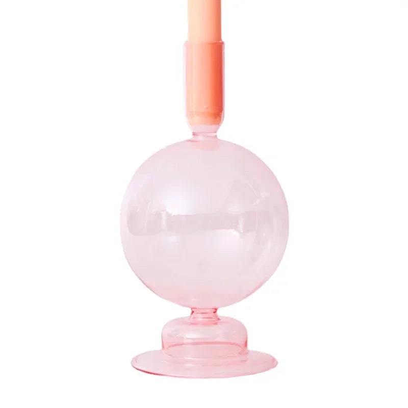 Pink spherical object with a peach-colored handle on a white background