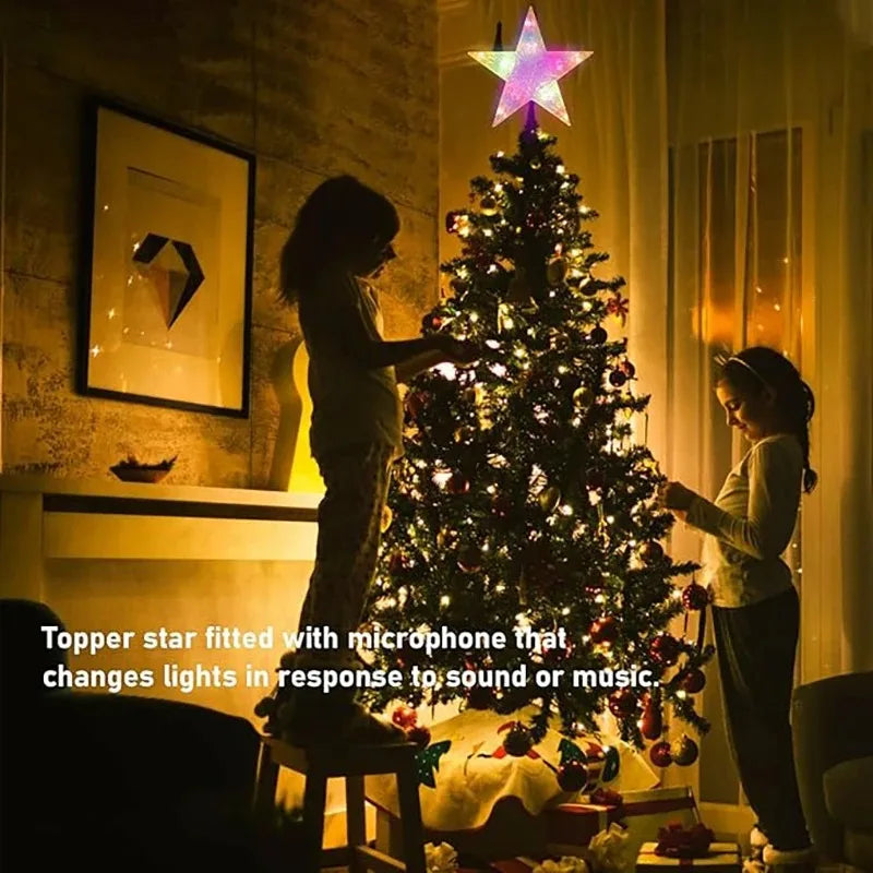 Two children decorating a Christmas tree with a colorful star topper.