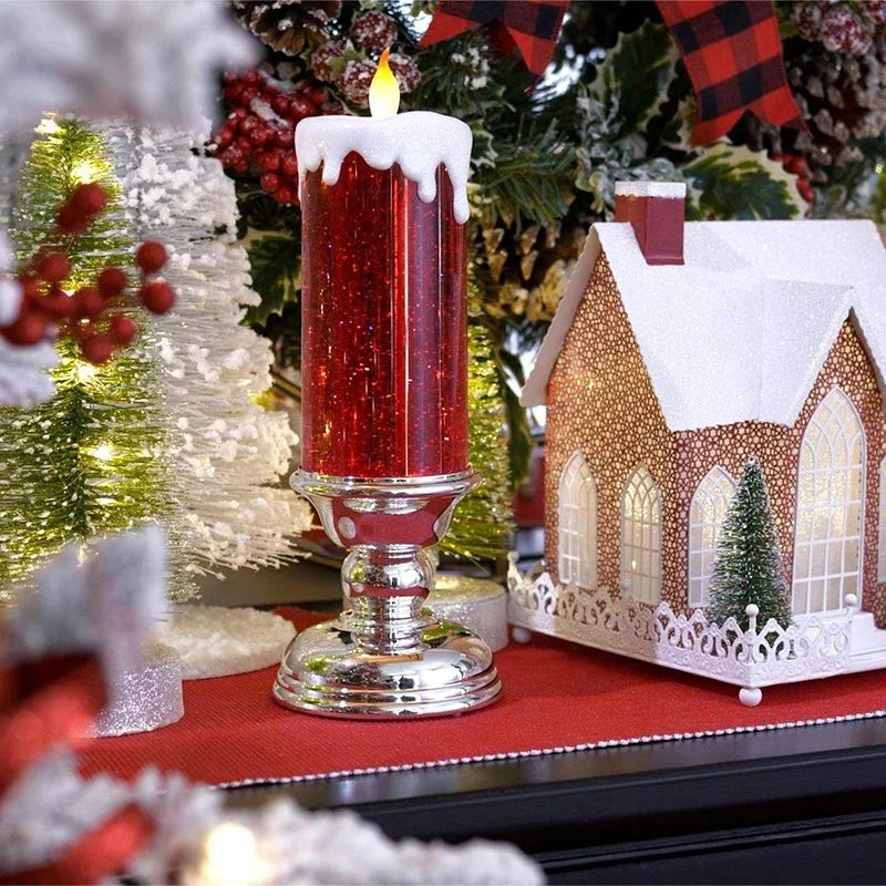 Decorative candle with a Christmas-themed setting including a small house and trees.