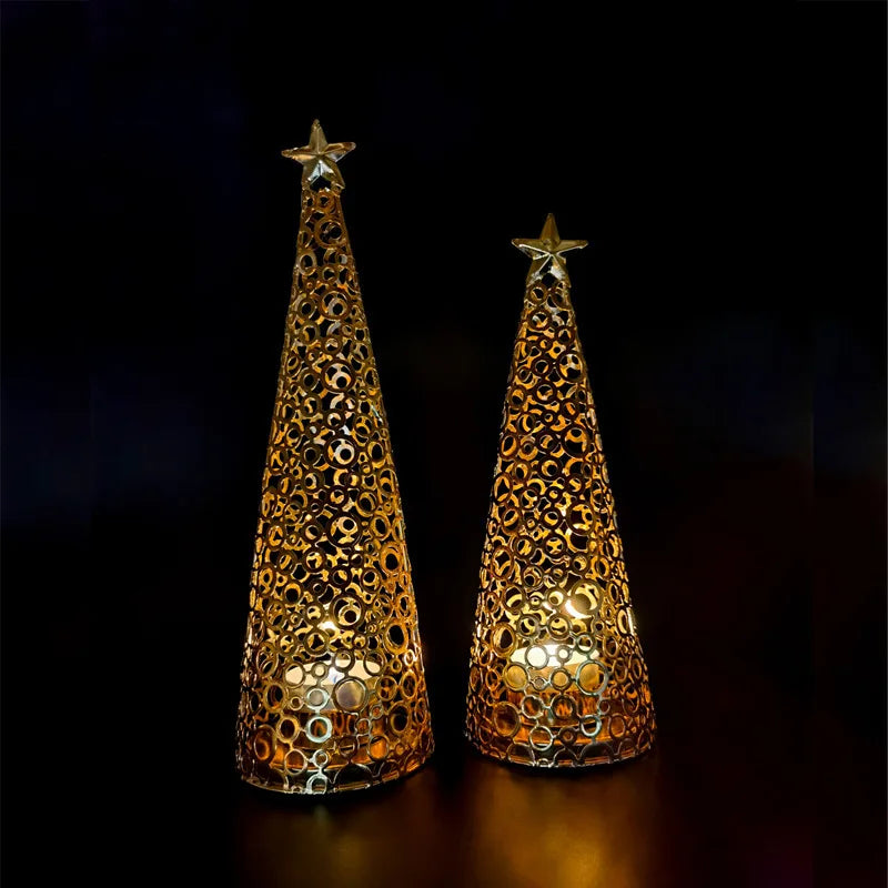 Two decorative cone-shaped lights with star tops on a dark background