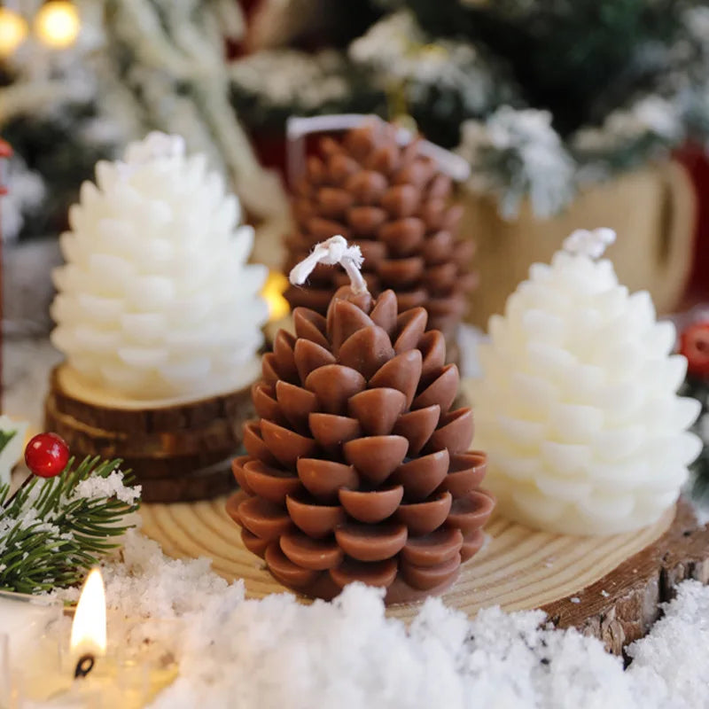 Decorative pine cone candles on a wooden base with a Christmas tree and lights in the background.