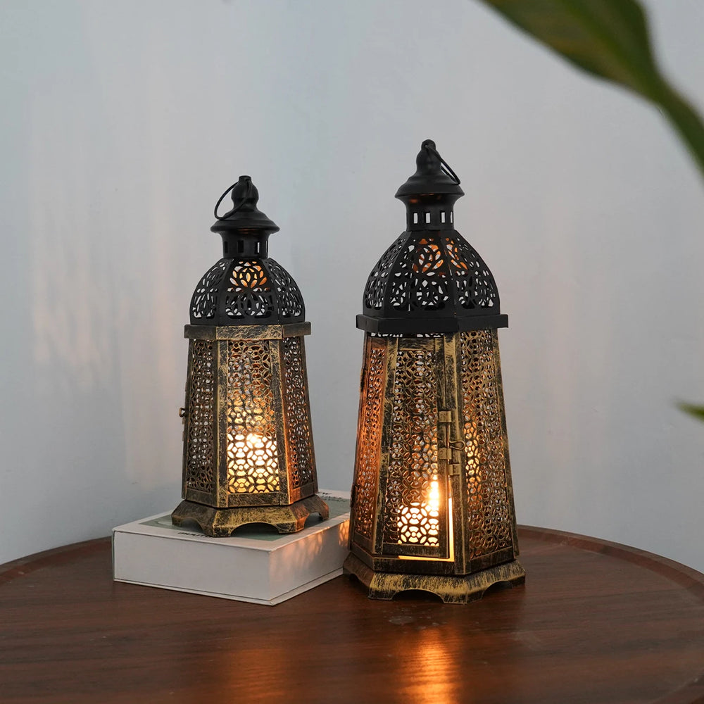 Two ornate lanterns on a wooden surface with a neutral background