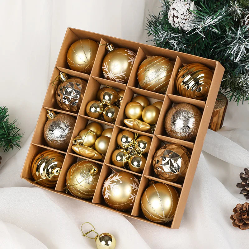 Box of gold Christmas ornaments on a white surface with a Christmas tree in the background