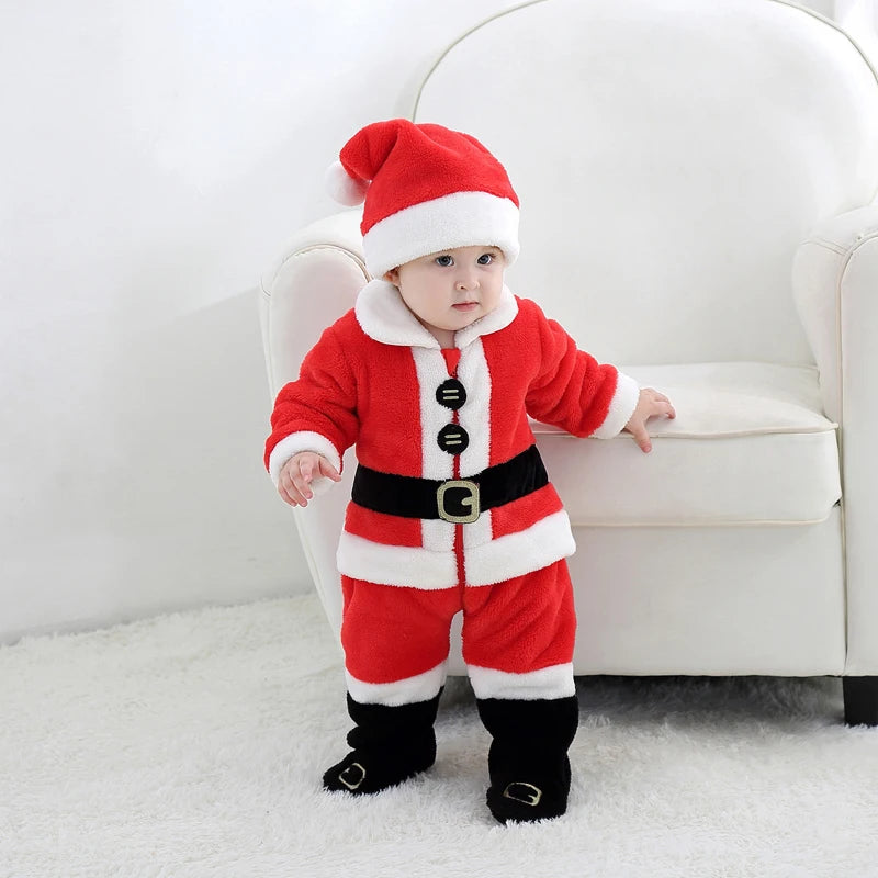 Baby wearing a red Santa Claus outfit standing on a white carpet.
