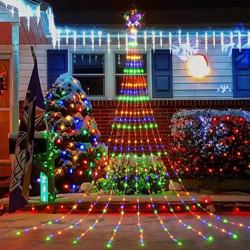 Decorative Christmas lights on a house exterior with a tree and wreath.