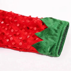 Red sequined fabric with green trim on a white background