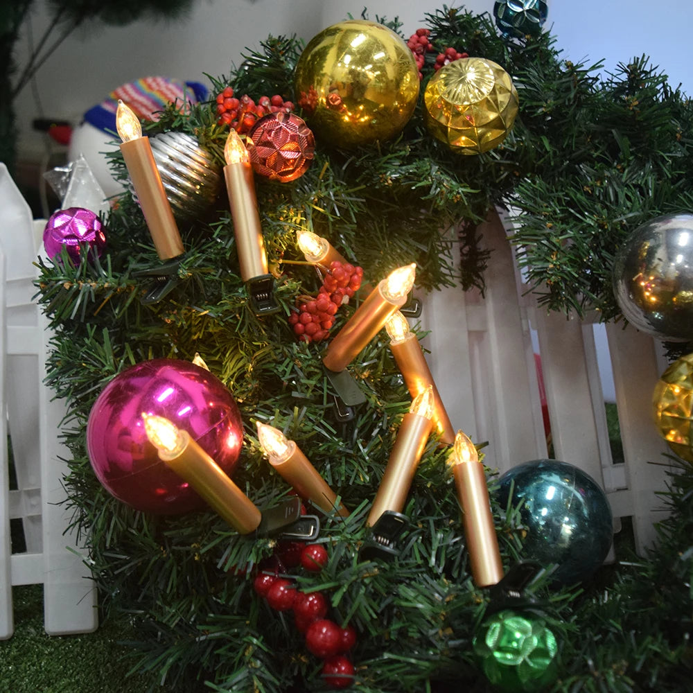 Decorative Christmas wreath with colorful ornaments and candles on a grassy background