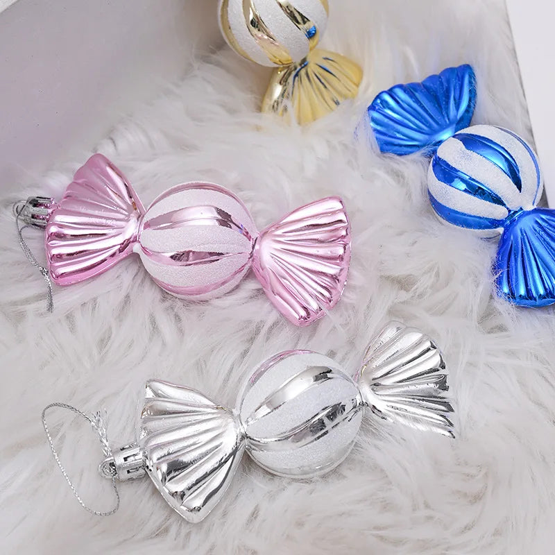 Decorative candy ornaments in pink, blue, and silver on a white surface.