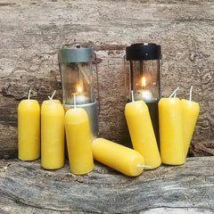 Yellow candles and lanterns on a wooden surface