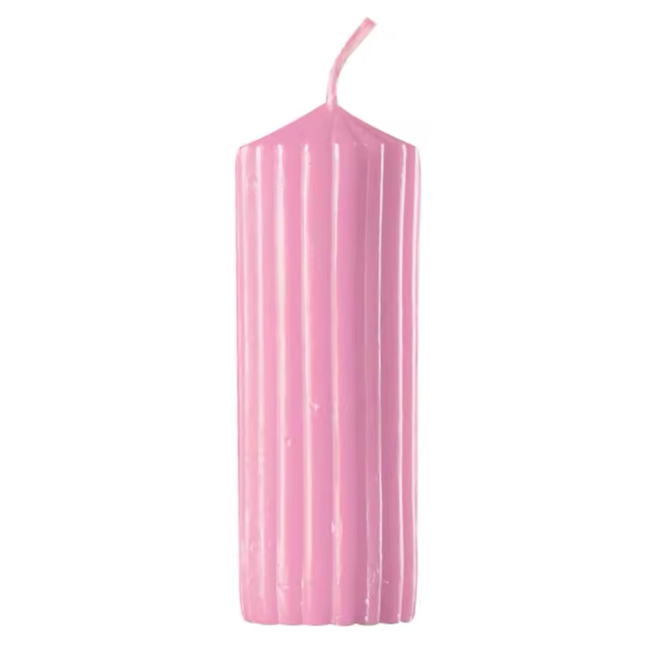 Pink candle with a wick on a white background